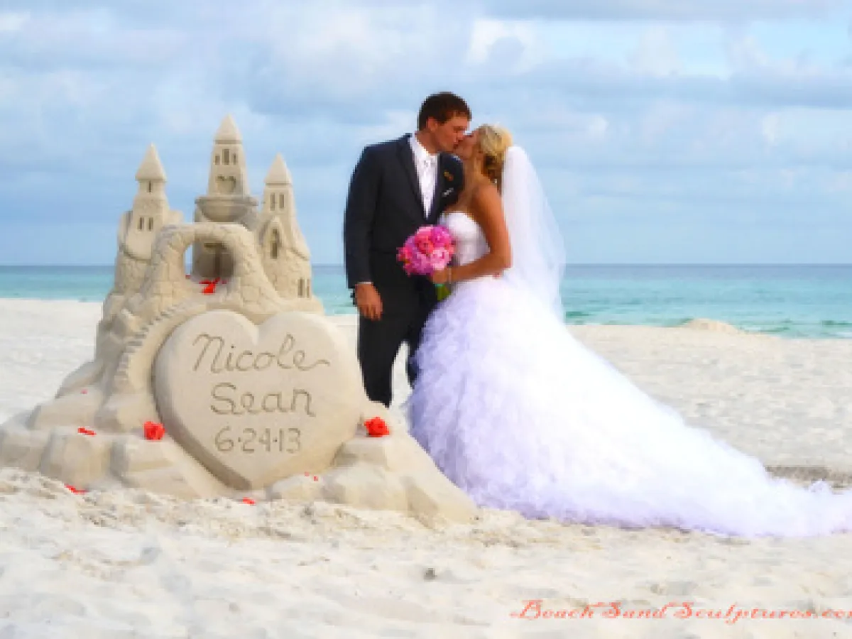 wedding picture with a sand sculpture