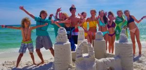 a group of people standing on a beach